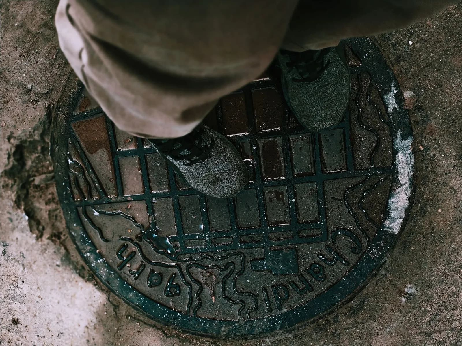 Engineer standing over a manhole cover