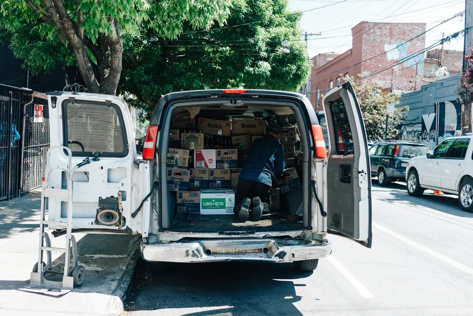 Work van with its rear doors open, loaded with equipment